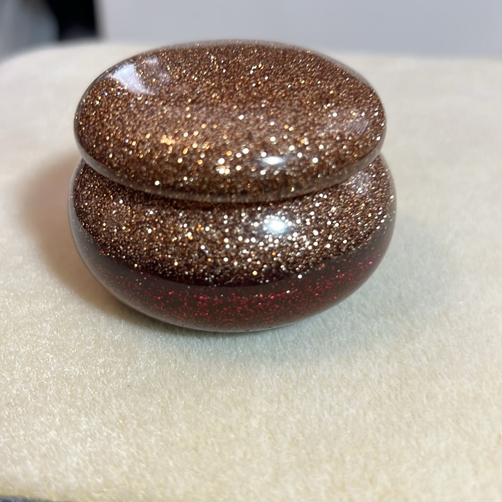 Red and gold glitter resin trinket container with lid.